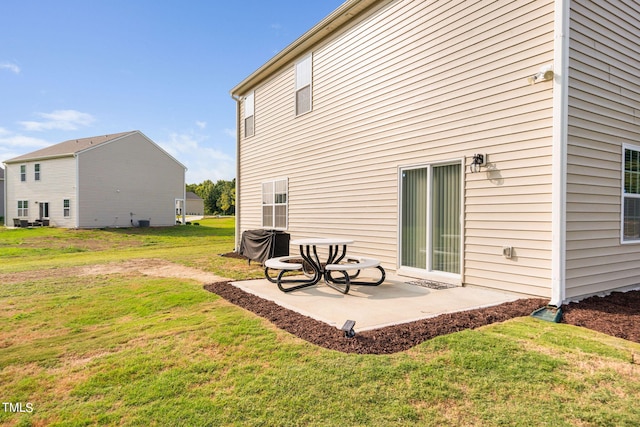 rear view of property with a yard and a patio area