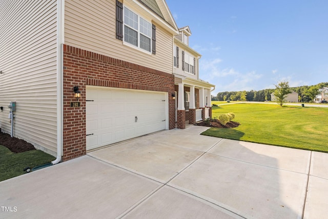 view of side of home with a yard and a garage