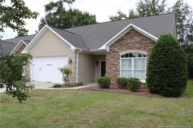 view of front of house featuring a garage and a front lawn