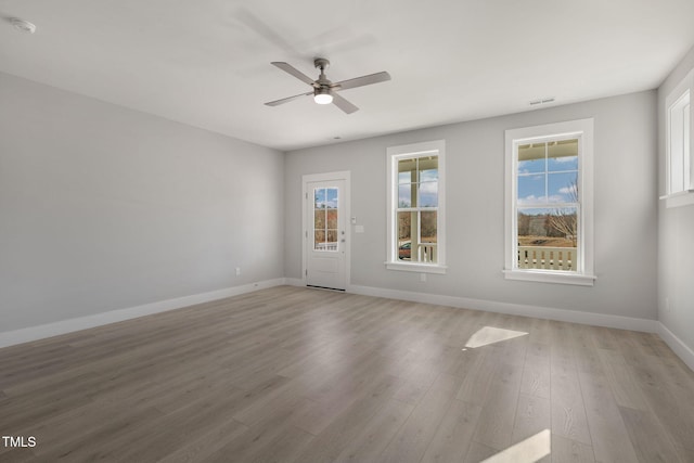 empty room featuring ceiling fan and light hardwood / wood-style floors