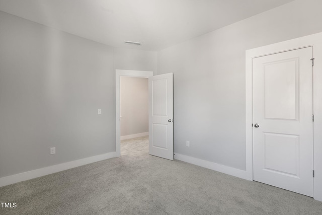 unfurnished bedroom featuring light carpet