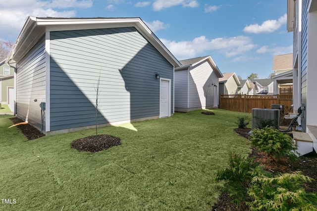 view of home's exterior featuring cooling unit and a lawn