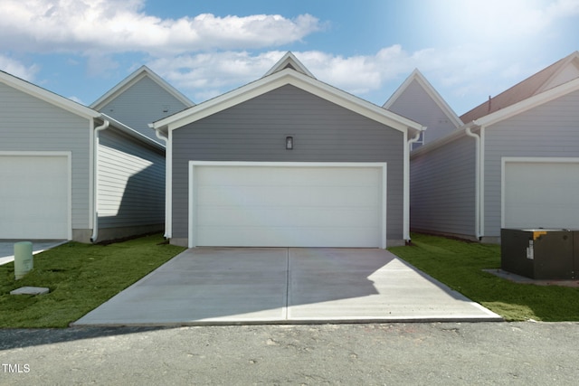 view of front of property featuring an outbuilding, a garage, and a front lawn