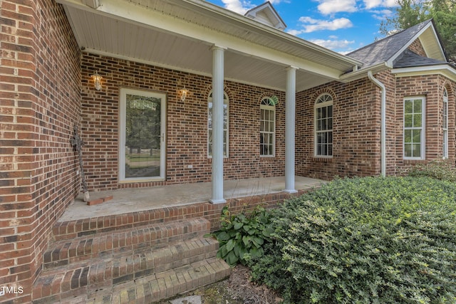 view of exterior entry featuring a porch