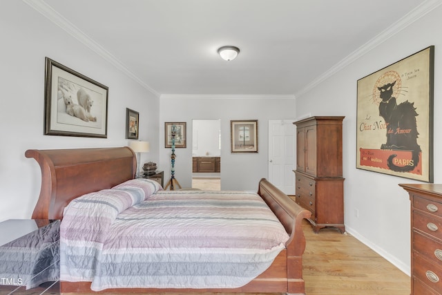 bedroom featuring crown molding, light wood-type flooring, and ensuite bathroom