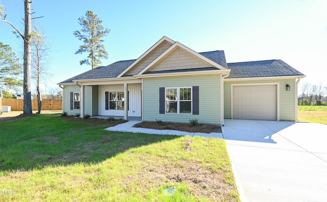 view of front of property featuring a front yard and a garage