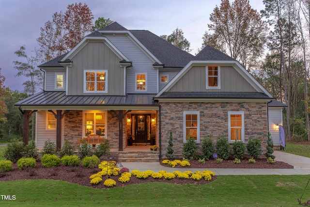 craftsman inspired home with a lawn and a porch