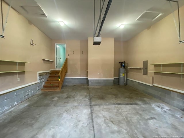 garage featuring electric panel and water heater