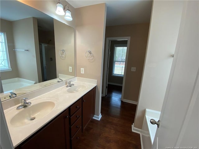 bathroom featuring vanity, independent shower and bath, and hardwood / wood-style flooring