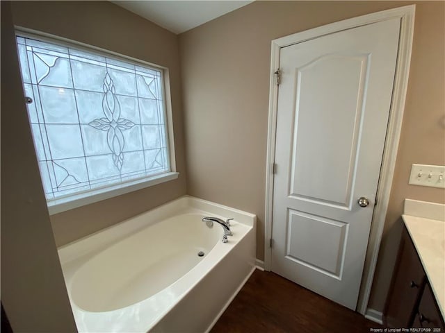 bathroom featuring a tub, wood-type flooring, and vanity