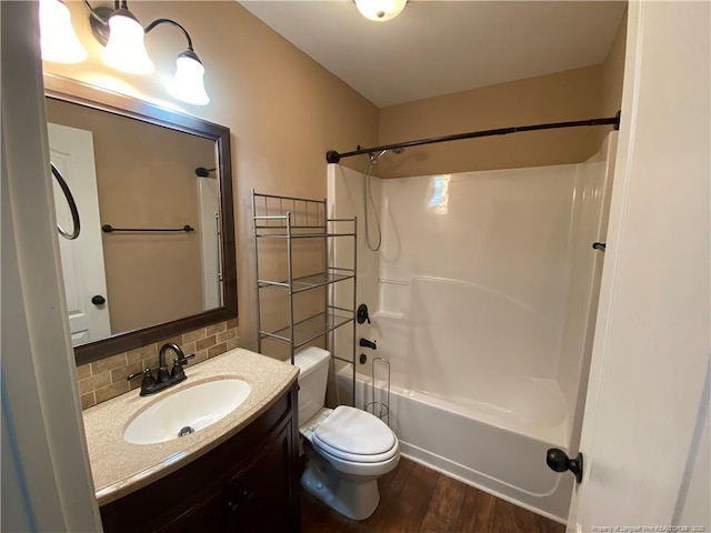 full bathroom featuring shower / tub combination, vanity, tasteful backsplash, toilet, and hardwood / wood-style flooring