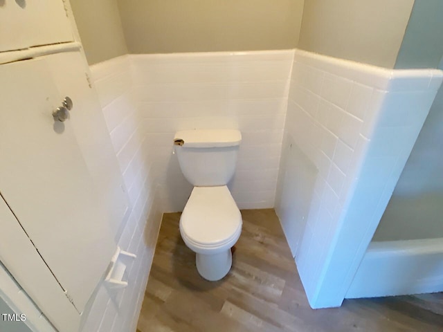 bathroom featuring toilet and wood-type flooring