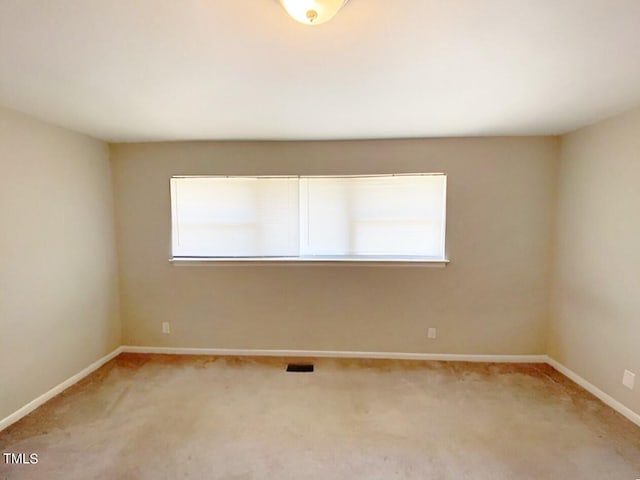 empty room with light colored carpet