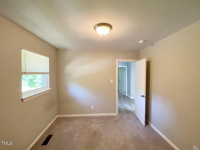 unfurnished room featuring carpet flooring