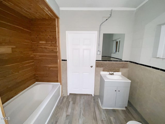 bathroom with vanity, hardwood / wood-style floors, tub / shower combination, and wooden walls