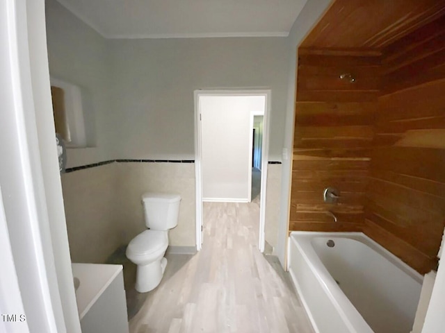 bathroom with toilet and hardwood / wood-style flooring