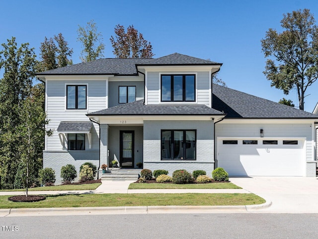 view of front of property with a garage and a front lawn