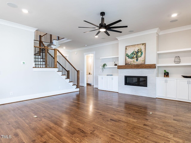 unfurnished living room featuring built in shelves, crown molding, ceiling fan, and dark hardwood / wood-style floors