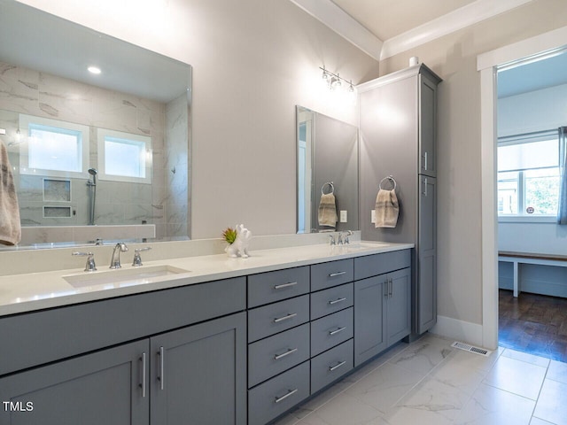 bathroom featuring tiled shower, vanity, hardwood / wood-style flooring, and crown molding