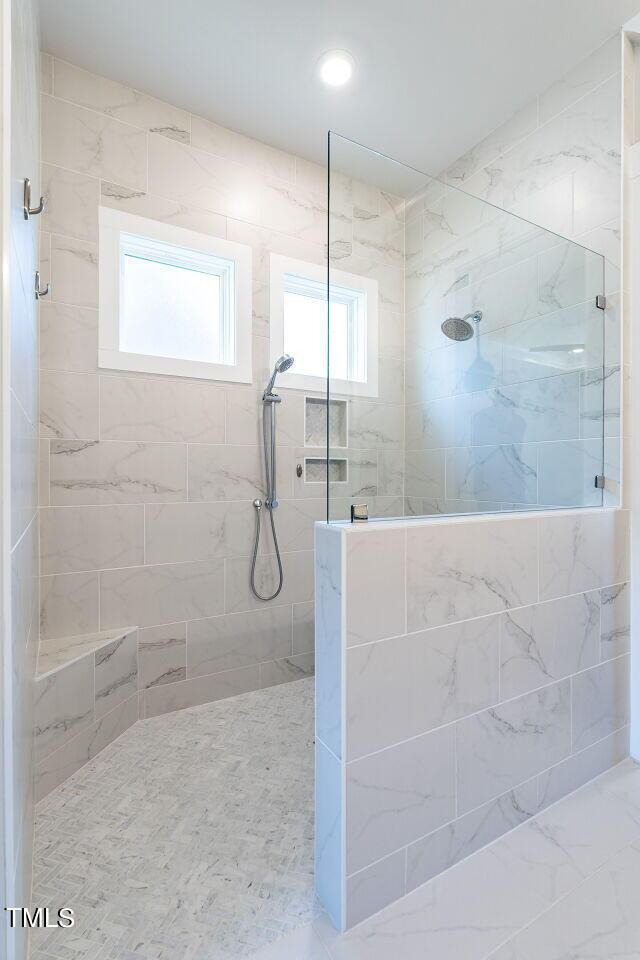 bathroom featuring tiled shower