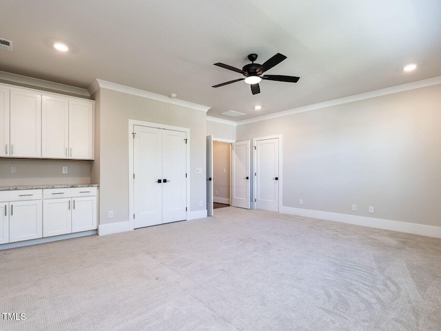 interior space featuring crown molding, light carpet, and ceiling fan