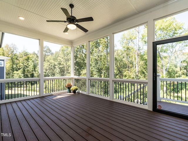 unfurnished sunroom with a wealth of natural light and ceiling fan