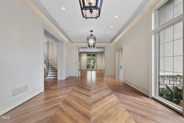 interior space featuring a chandelier, stairway, crown molding, and baseboards