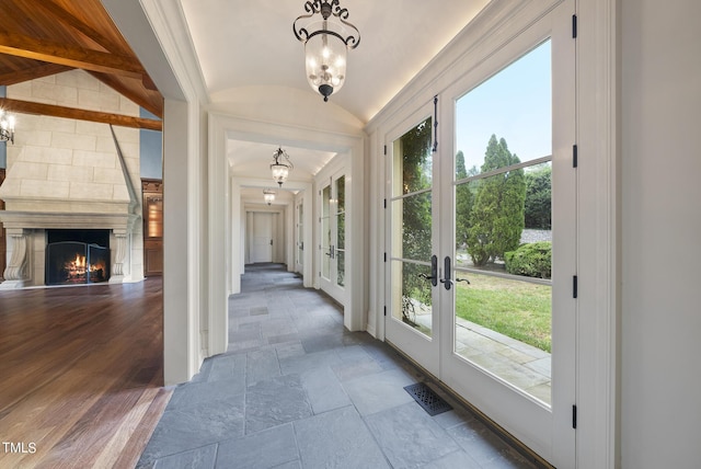 entrance foyer with vaulted ceiling, stone tile floors, plenty of natural light, and visible vents