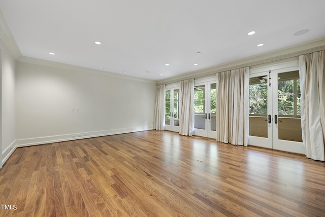 empty room with recessed lighting, french doors, wood finished floors, and crown molding