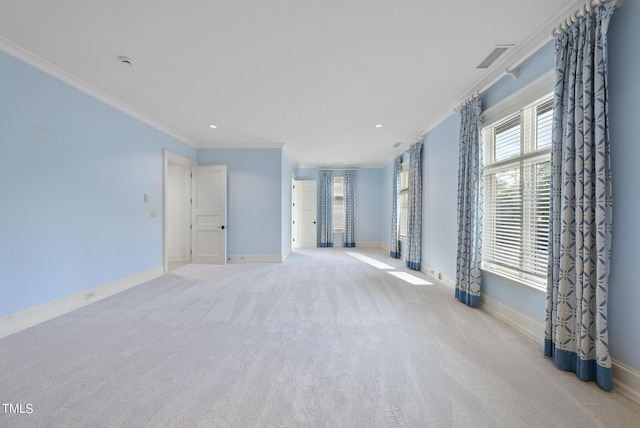 spare room featuring carpet flooring, crown molding, and baseboards