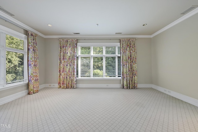 empty room with visible vents, baseboards, and ornamental molding