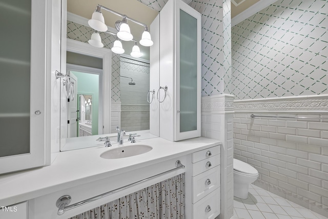 bathroom featuring tile patterned floors, toilet, wallpapered walls, and tile walls