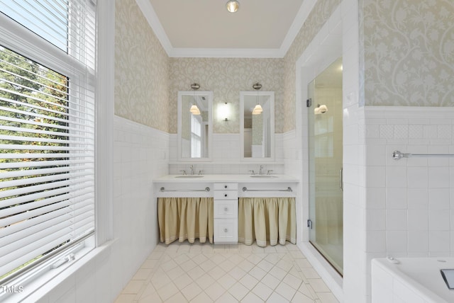 full bathroom with a wainscoted wall, a shower stall, wallpapered walls, and a sink