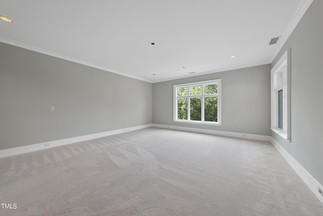 unfurnished room featuring visible vents, baseboards, light carpet, and ornamental molding