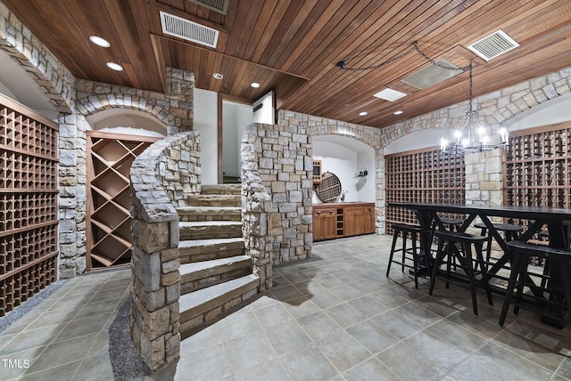 wine area featuring an inviting chandelier, recessed lighting, wood ceiling, and visible vents