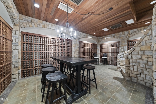 wine room with visible vents, a chandelier, wood ceiling, recessed lighting, and tile patterned floors