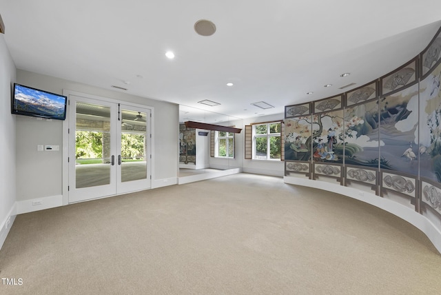 unfurnished living room with recessed lighting, french doors, baseboards, and carpet