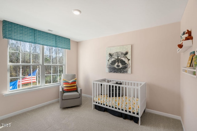 bedroom with a crib and carpet floors