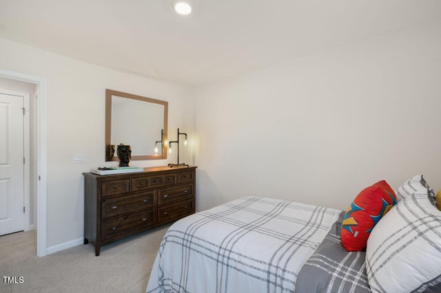 bedroom featuring light carpet