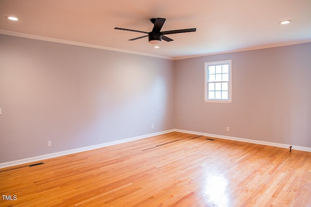 empty room featuring crown molding, ceiling fan, and light wood-type flooring