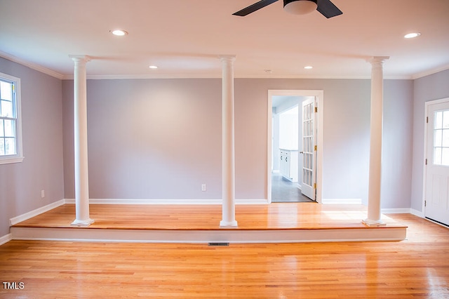 interior space featuring light wood-type flooring, ornamental molding, and ceiling fan