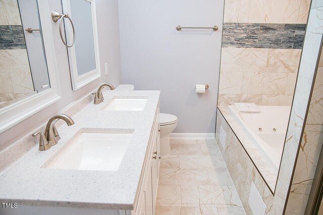 bathroom featuring toilet, tiled tub, and vanity