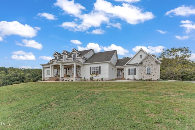 craftsman house with a porch and a front lawn