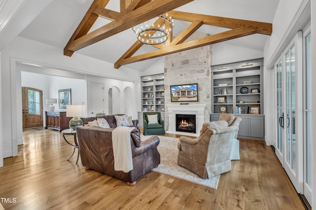 living room featuring beamed ceiling, light hardwood / wood-style floors, a chandelier, and high vaulted ceiling