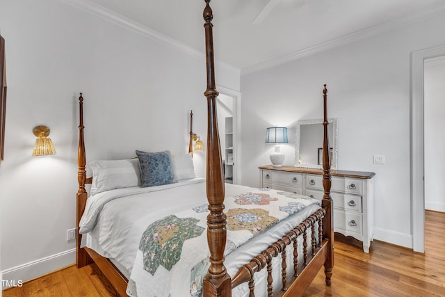 bedroom featuring light hardwood / wood-style floors and crown molding