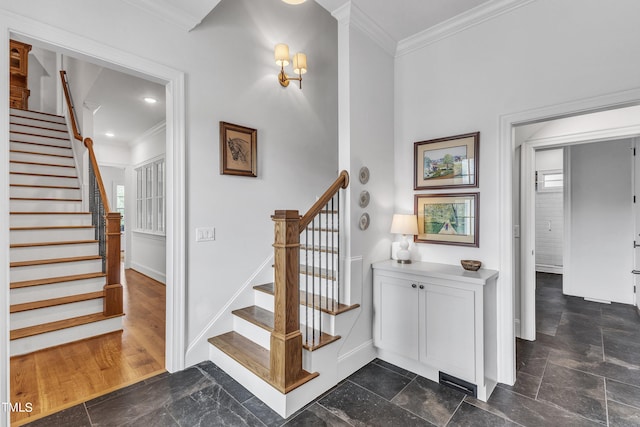 stairway featuring hardwood / wood-style floors and ornamental molding