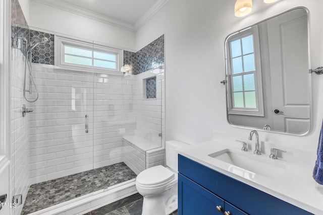 bathroom with vanity, toilet, an enclosed shower, and crown molding