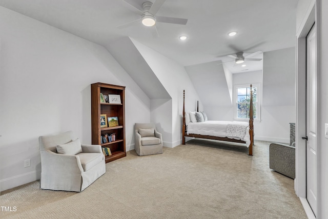 bedroom featuring ceiling fan, vaulted ceiling, and light colored carpet