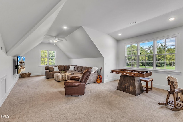 carpeted living room with ceiling fan, a healthy amount of sunlight, and vaulted ceiling