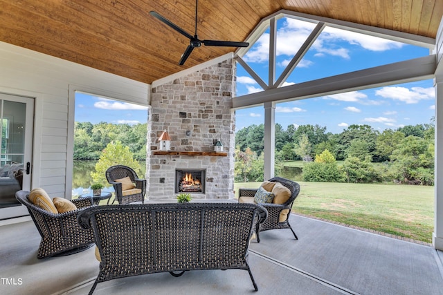 view of patio / terrace featuring ceiling fan and an outdoor stone fireplace